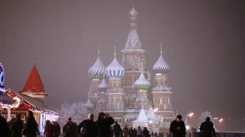 People walk around Saint Basil's Cathedral in snowfall, Moscow, Russia Video stock 45296473