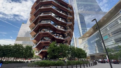 People walk around the Vessel structure. Hudson Yards Square. New York City Stock Footage 337837956