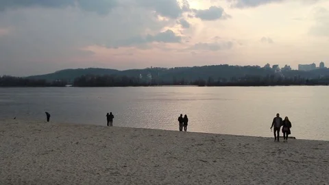 People walk on the beach in the evening Stock Footage 109802002