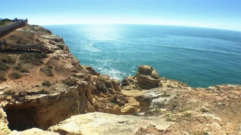 People Walk In Cliff of Rocks Over Amazing Ocean Landscape Stock Footage