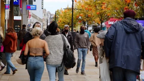 People walk down busy street during coronavirus outbreak. Stock Footage