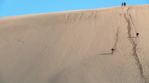 People walk down the face of huge sand dune Stock Footage 39564720