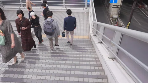 People walk on the Elevated pedestrian bridge around Shibuya Station in Tokyo Stock Footage 282673167