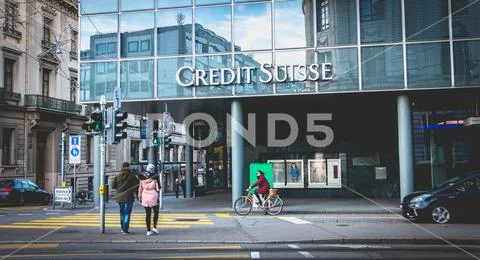 People walk in front of an agency of Credit Suisse business bank Stock Photos