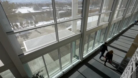 People walk inside the Dwire Center, University of Colorado Colorado Springs. Stock Footage 99999372