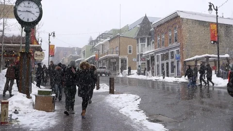 People walk on Main Street while snowing during the Sundance Film Festival. Stock Footage 98005889
