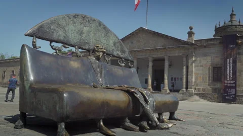People walk near Alejandro Colunga bronze sculptures at Cabanas museum plaza Stock-Footage 345618085