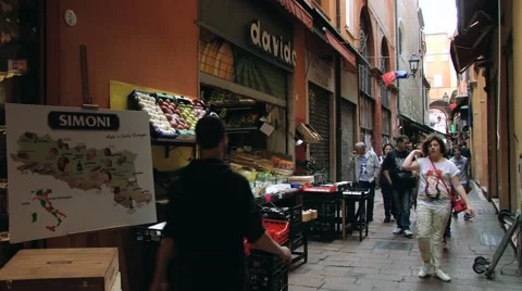 People walk by the old market street in Bologna, Italy. Stock Footage 59790186