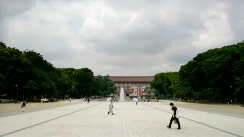 People walk past Ueno Park Fountain in front of the Tokyo National Museum. Stock Footage