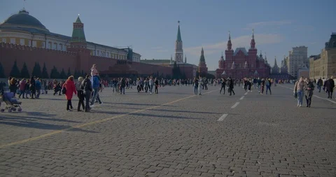People walk on red square, warm autumn day Stock Footage 96587989