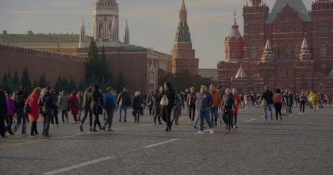 People walk on red square, warm autumn day Видео 96588059