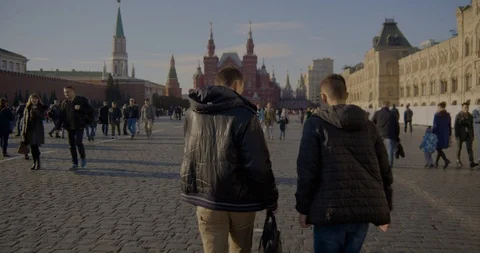 People walk on red square, warm autumn day Stock Footage