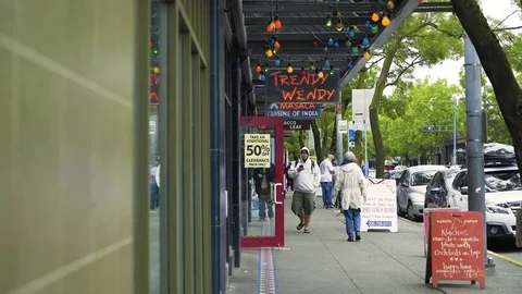 People walk by on sidewalk in Seattle Stock Footage 73497397
