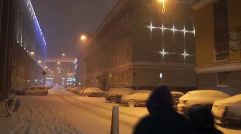 People walk in a snowy evening Stock Footage 60761153