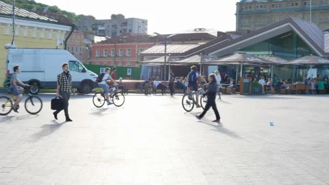 People walk in spring on the square filled with sun rays in Kyiv, Ukraine - Stock Footage 171586588