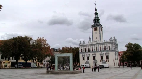 People walk by the square in front of the town hall building in Helmno, Poland. Stock Footage 58636639