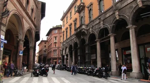 People walk by the street of the historical center in Bologna, Italy. Stock Footage 59779022