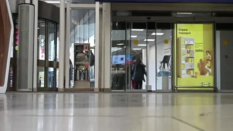 People walk through automatic doors in the Mall. The entrance to IKEA Stock Footage 133558485