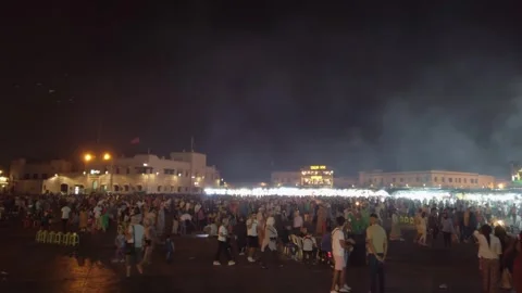 People walk through the crowded evening market in Marrakesh's Jemaa el-Fnaa Stock Footage 336757333