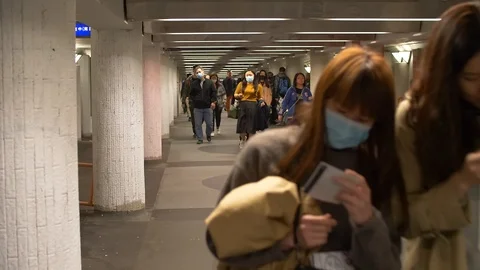 People Walk through crowded underground pathway 4k Stock Footage 123142096