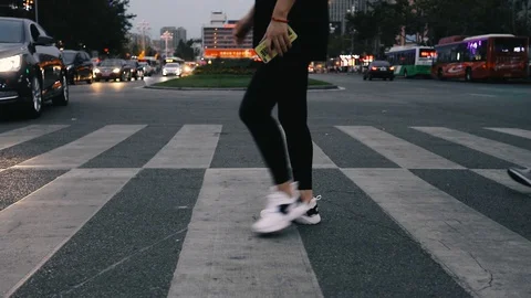 People walk through the zebra crossing Stock Footage 129347635