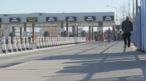 People Walk Toward Border Crossing Stock Footage 60631392