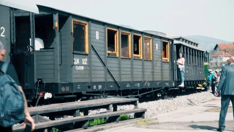 People walk by the Train at the Station Stock Footage 93552550