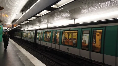 People Walk While a Metro Train Departs Stalingard Underground Station in Stock Footage 255118504