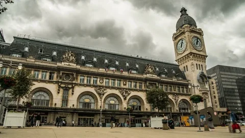 People walking across square in front of entrances to Lyon railway terminal Stock Footage 74989297