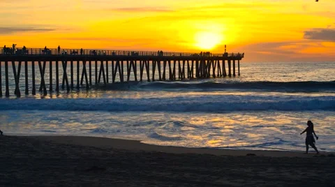 People walking along beach during sunset Stock Footage 60720199