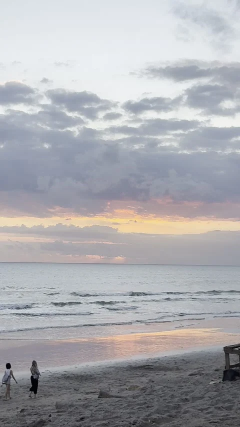 People Walking Along Beach During Dramatic Orange Sunset by the Ocean Stock Footage 340390210