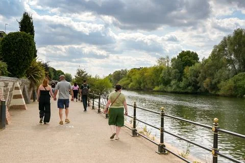 People walking along the path alongside the River Severn in Worcester Stock Photos