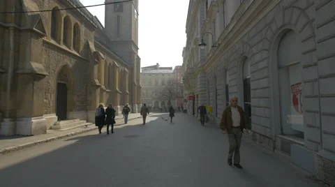 People walking along the Sacred Heart Cathedral in Sarajevo Stock Footage 59794853