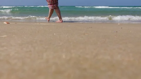 People walking along the seashore. Sea or ocean tropical view Stock Footage 260237953