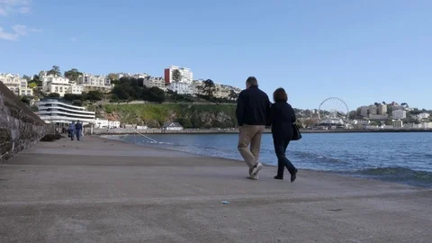 People walking along seaside path Stock Footage 74603935