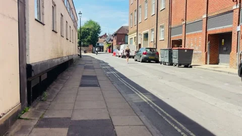 People walking along St Peter Street with historic and modern buildings in Stock Footage 340597699