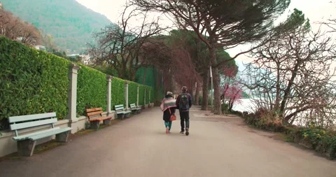 People Walking Along Tree Lined Promenade Beside Lake Geneva Stock Footage 337435226