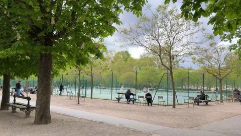People walking and enjoying a spring day in a Paris park Stock Footage 337782756