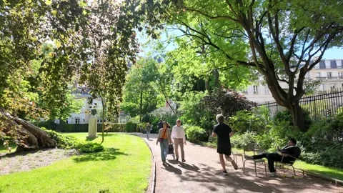People Walking and Jogging Through a Sunny Park in Paris France Stock-Footage 335799589