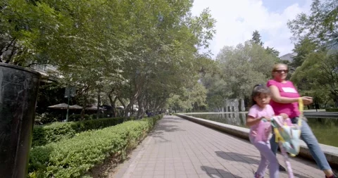 People walking and reflecting pool in Lincoln Park, Polanco, CDMX Stock Footage 250360890
