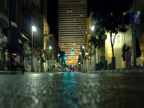 People Walking and riding bicycles on the road in the night in Tel Aviv Stock Footage