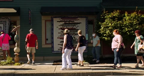 People walking around and looking at quilts during the Sisters Outdoor Quilt Stock Footage 228723611