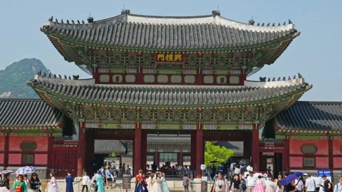 People walking around main gate at Gyeongbokgung Palace in seoul with busy 스톡 동영상 345020345