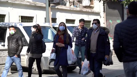 People walking around Taksim and Istiklal Avenue in masks on Corona Stock Footage 148478053