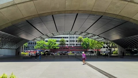 People walking in Ayala Triangle Gardens with modern architecture in Makati Stockbeeldmateriaal 309268415