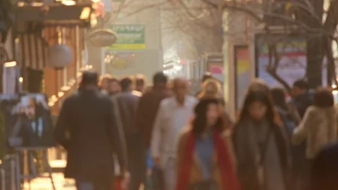 People walking on the background golden sunset in the city. Defocused video Stock Footage 84183448