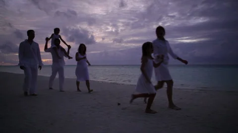 People walking on beach after sunset Stock Footage 1055925