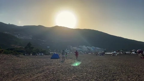 People walking on the beach during sunset Stock Footage 210537352
