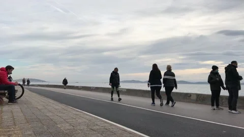 People walking on the beach Stock Footage 144817645