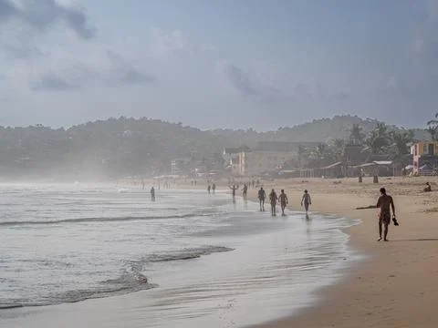 People walking on the beach Stock Photos